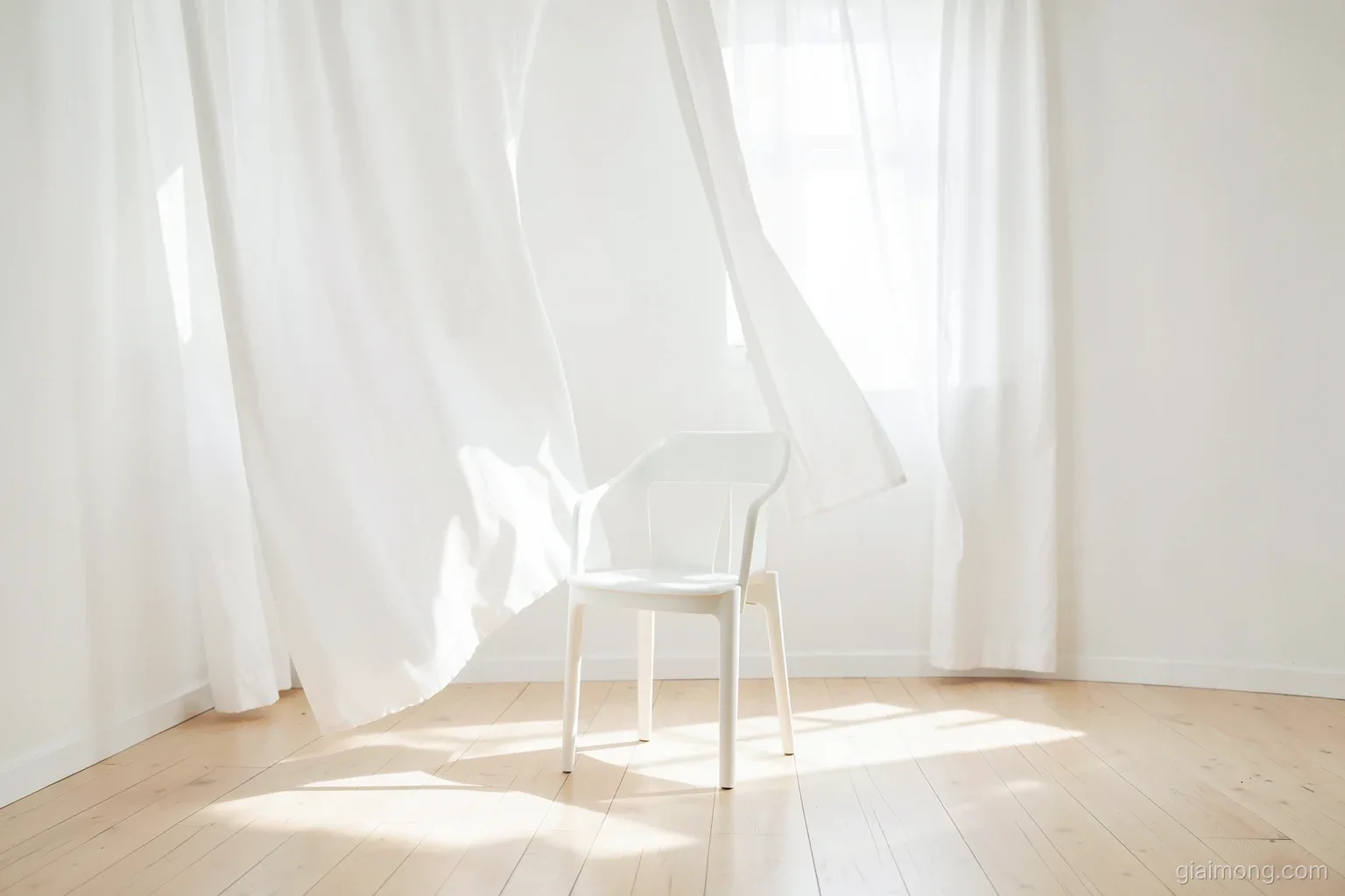 Long white curtains billowing into an empty sunlit room with pale wooden floor, a single white chair, soft overexposed morning light, airy and quiet